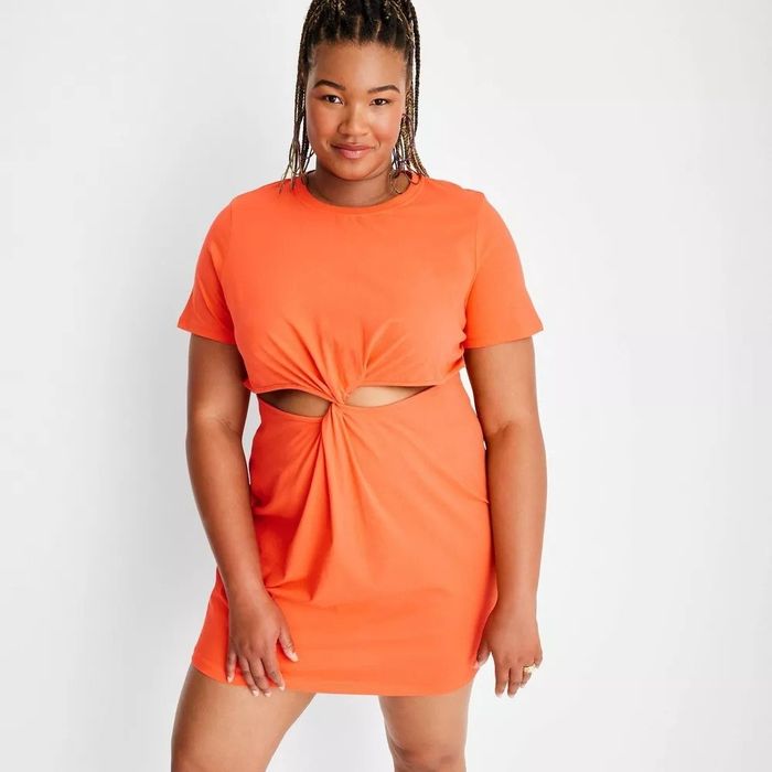 A model wearing the orange cut-out dress