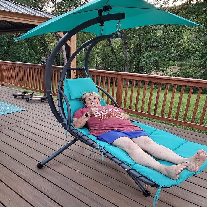 a reviewer lounging on their teal chaise lounge