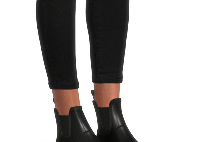 A model showcasing the black ankle boots