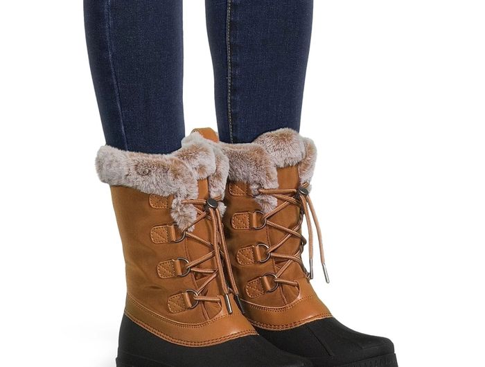 A model wearing the calf-high boots in a tan and black combination