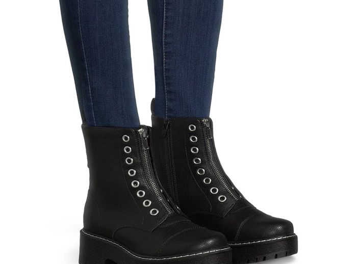 The black boots feature grommets, a front zipper design, contrast stitching, lug soles, and side zippers