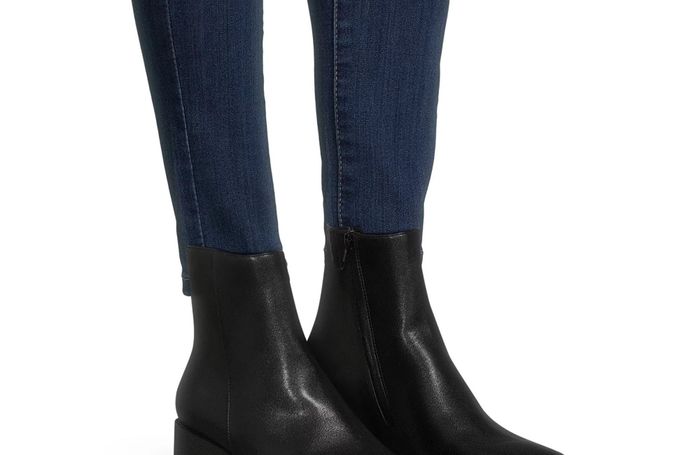 A model showcasing the black boots with convenient side zippers