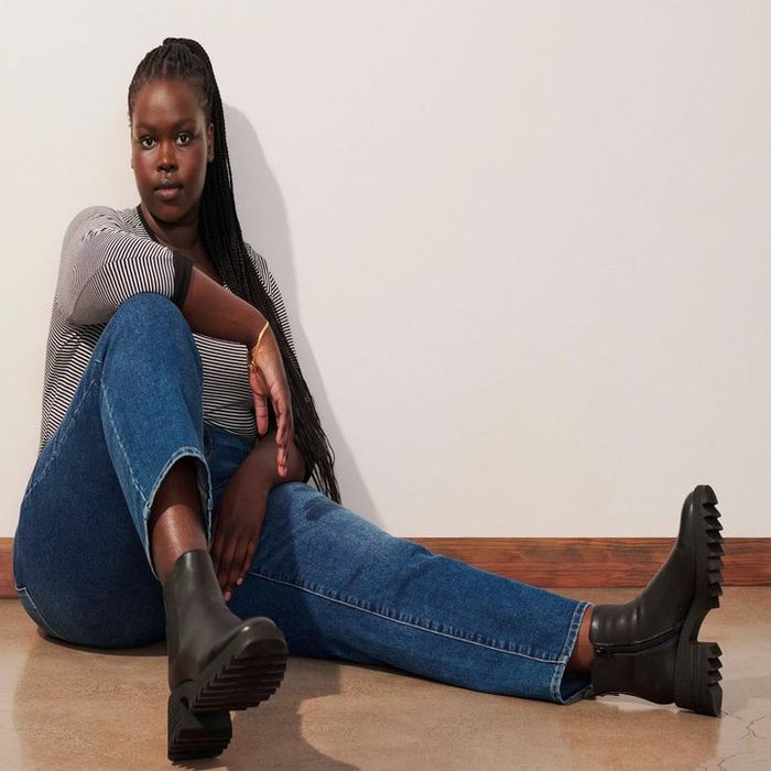 A model wearing the sleek black pull-on boots