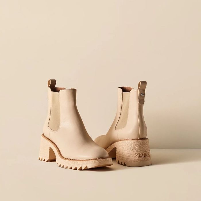 The cream-colored boots, featuring elastic side panels and a chunky sole