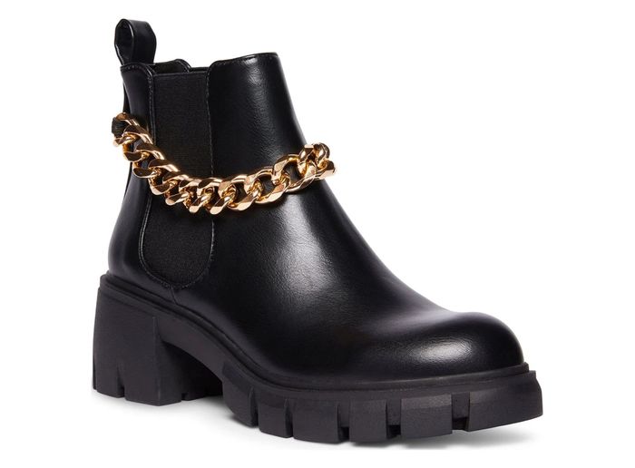 The boot featuring a gold chain accent around the ankle
