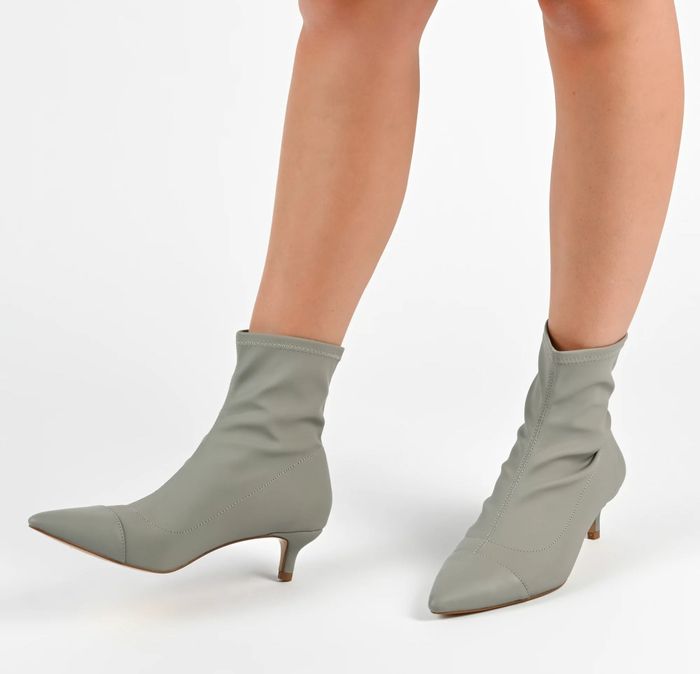 A model wearing the gray boots