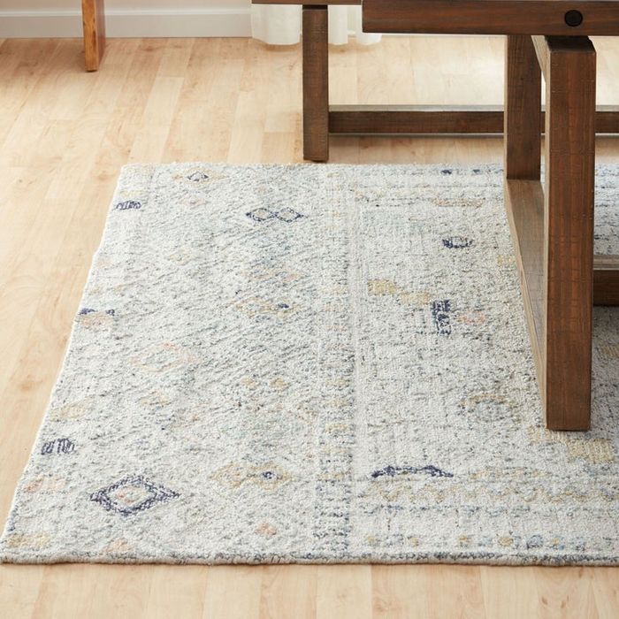 A beautiful beige and blue area rug with a Moroccan-style design, perfect for adding warmth and elegance to your space.