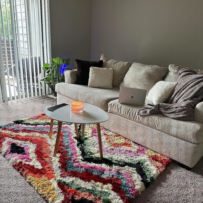 reviewer photo of a vibrant rug in a living room setting