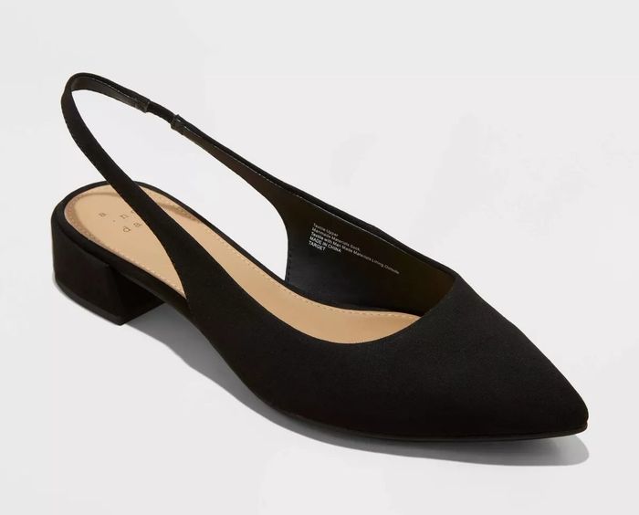 A single black slingback flat featuring a pointed toe and a low block heel.