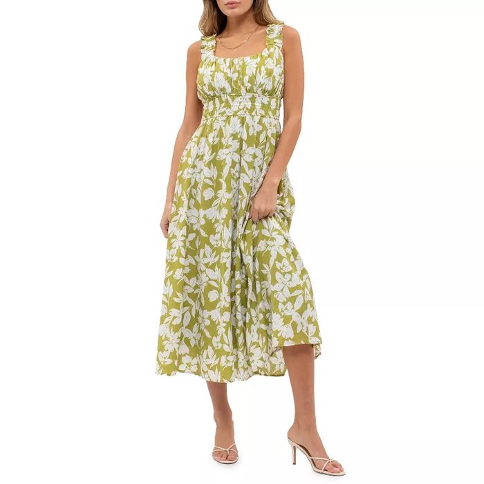 A person wearing a floral sundress and sandals poses gracefully, embodying casual elegance for a shopping feature.