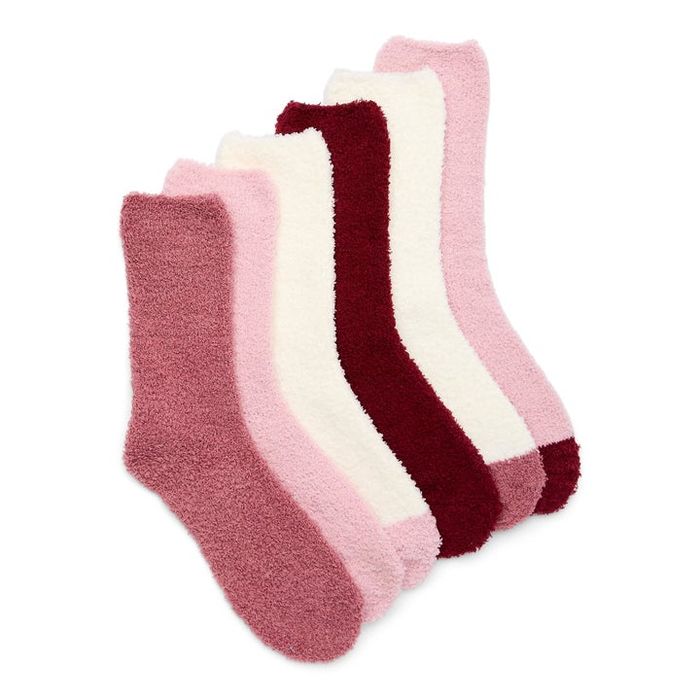 Five pairs of plush socks arranged neatly, offering various shades of pink and cream, perfect for staying cozy and comfortable during any season.