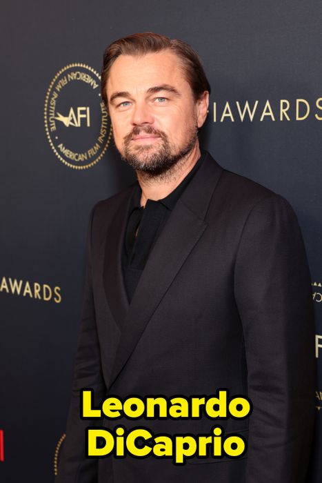 A person in a black suit at an awards ceremony backdrop, with the AFI logo visible