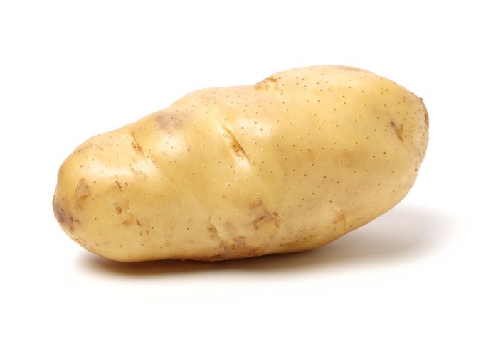 A single, unpeeled potato on a white background