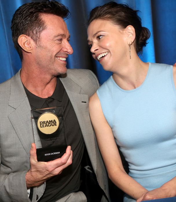 Hugh and Sutton sharing a smile with each other.