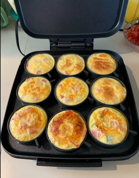Nine perfectly round egg bites cooked in a small grill