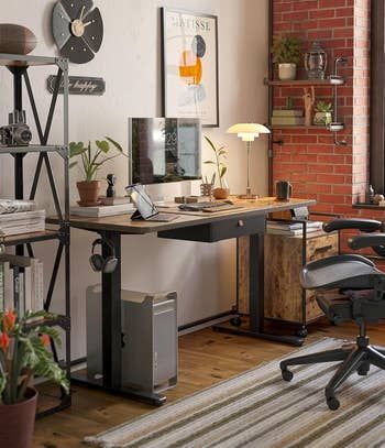 A contemporary home office featuring a standing desk, an ergonomic chair, and stylish decor