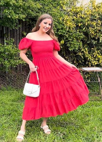 reviewer wearing a red dress