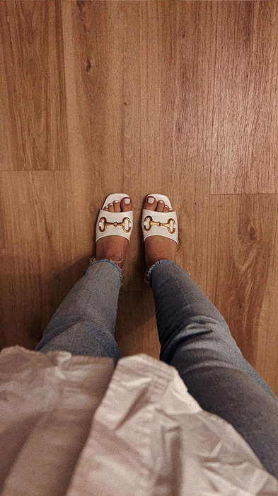 a reviewer wearing the elegant white heels