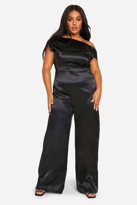 A person models a chic off-shoulder satin jumpsuit, posing with confidence