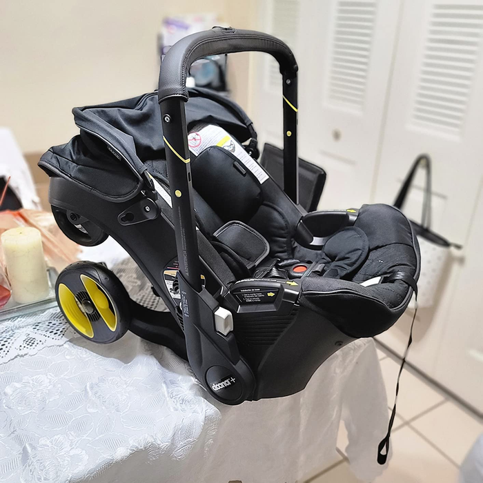 An infant car seat with a built-in wheeled base