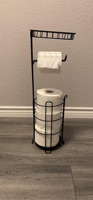 A photo from a reviewer showing the toilet paper stand holding four rolls of toilet paper.