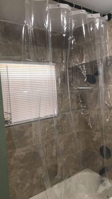 A reviewer's clear shower curtain liner.