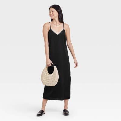 Model showcasing a black slip dress