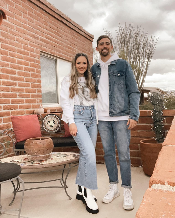 reviewer showcasing the white and black boots