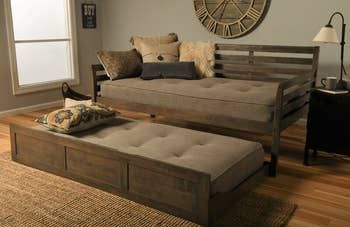 A lifestyle photo of mattresses placed on a trundle bed, detached from the main bed.