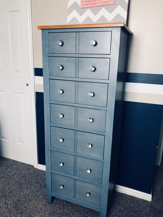 Reviewer photo of a tall, vibrant blue wooden dresser with clear crystal knobs enhancing the drawers.
