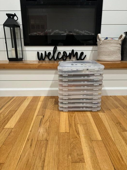 A pile of storage containers placed in front of a fireplace