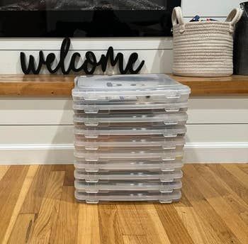 A pile of storage containers placed in front of a fireplace