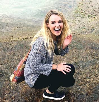 reviewer showcasing the black shoes outdoors