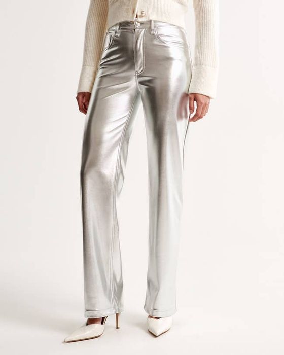 A model striking a pose in these eye-catching silver pants.