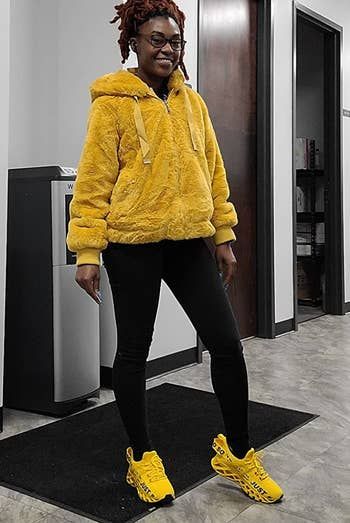 Reviewer showcasing the electric yellow version of the sneakers