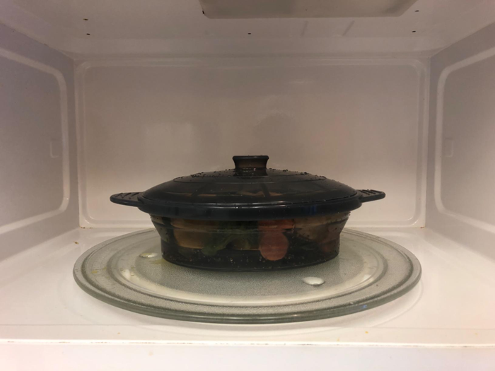A reviewer's photo of the steamer bowl inside a microwave, ready to use.