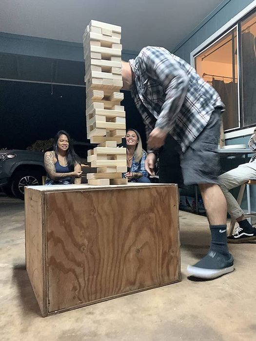A reviewer enjoying the giant stacking game