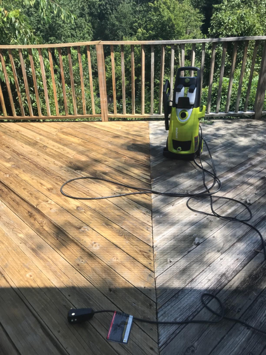 A reviewer’s image of a deck being washed, with one side still gray and dull while the other gleams with cleanliness