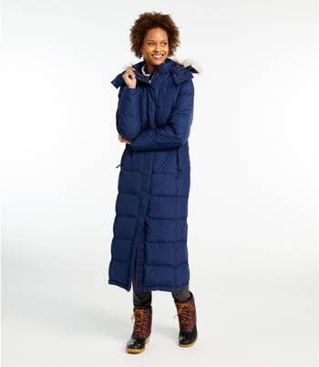 A model wearing the long jacket in blue.