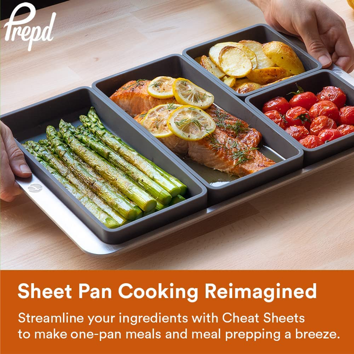 A model holding a sheet pan with four silicone dividers, each filled with a different food item