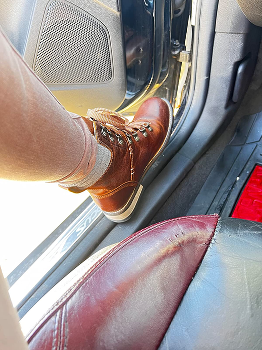 reviewer modeling the brown leather boots