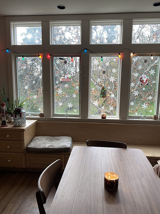 A reviewer's photo of the snowflake decals placed on four different windows