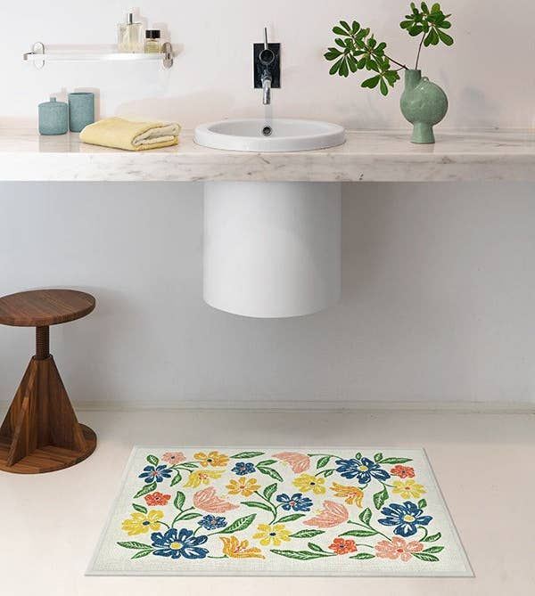 A floral Ruggable bath mat designed for quick washing and easy upkeep.