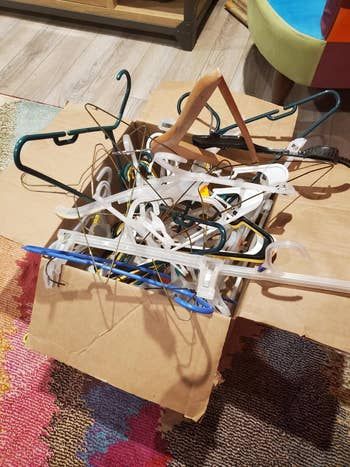A reviewer's box full of tangled, messy hangers.