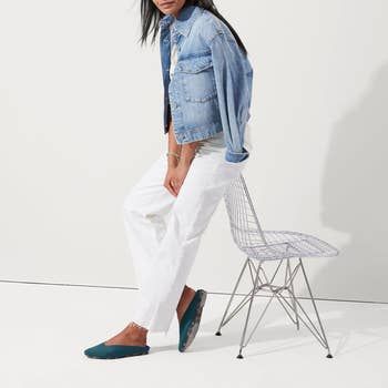 a model wearing the deep emerald mules