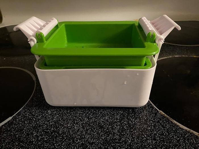 The tofu press in action, showcasing its functionality.