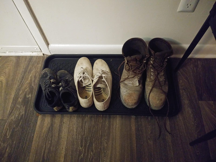 A reviewer’s image of the boot tray holding three pairs of shoes