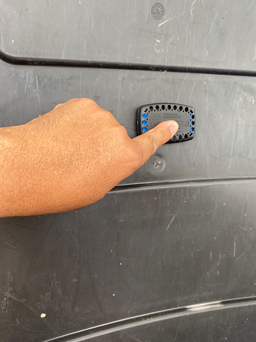 Image of the reviewer placing a garbage guard onto their trash can