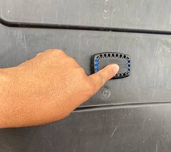 Image of the reviewer placing a garbage guard onto their trash can