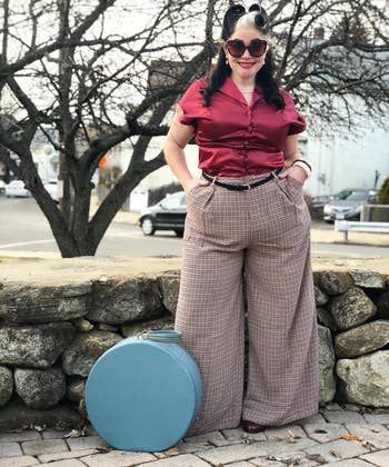 Reviewer wearing the brown plaid pants paired with a red top